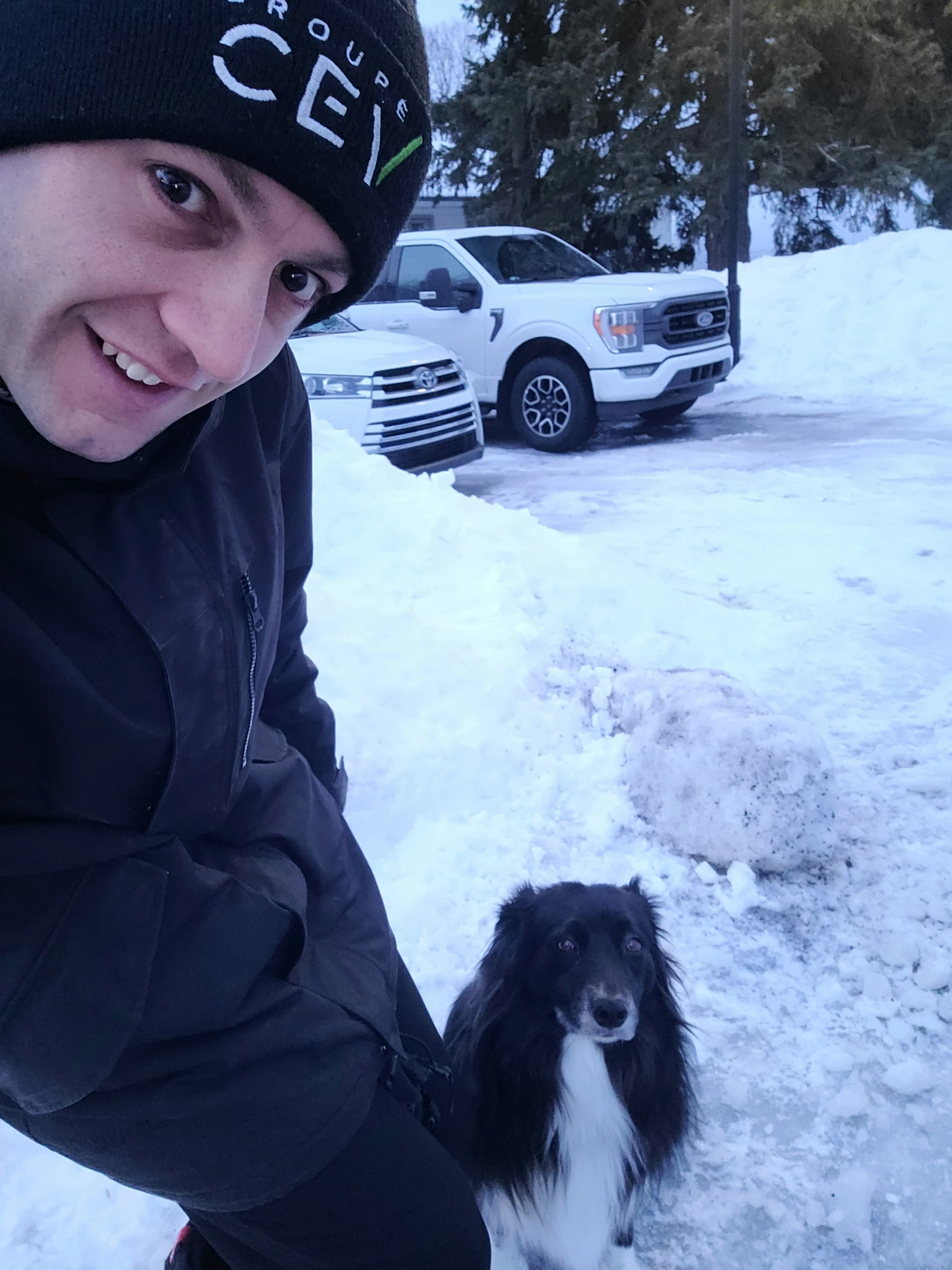 Un homme prenant un selfie avec son chien en hiver.